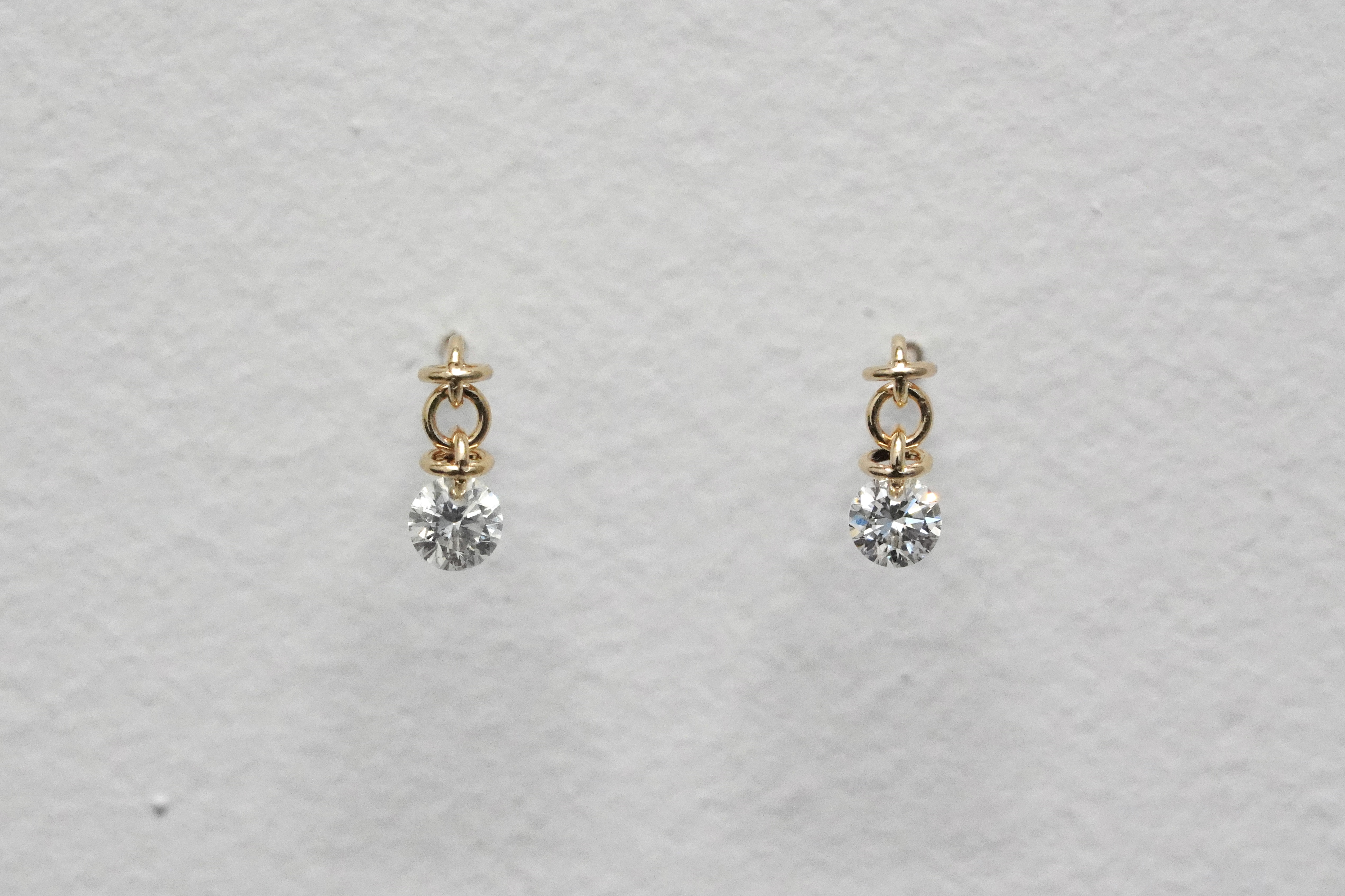 Hole diamond W cross stud earrings.